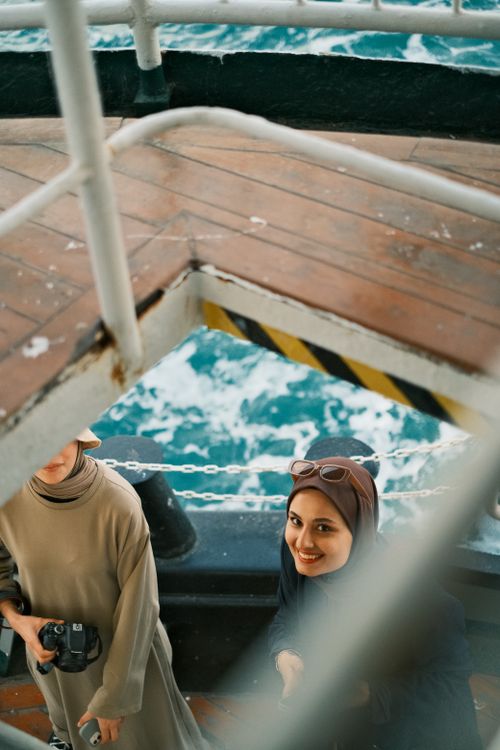 Free Two women enjoying a scenic ferry ride with a view of the ocean water. Stock Photo