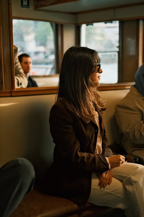A woman sitting on a bus with other people