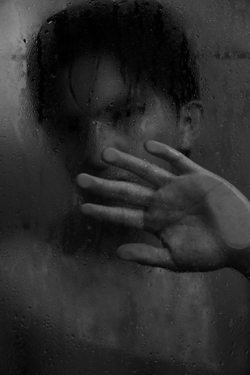 Free Artistic image of a person behind a wet shower glass in black and white. Stock Photo