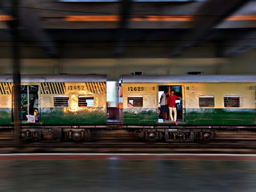 Man Wearing Red Shirt Standing By The Door Of A Train