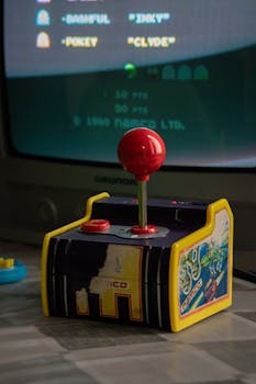 Retro gaming setup featuring a vintage joystick and classic arcade game display.