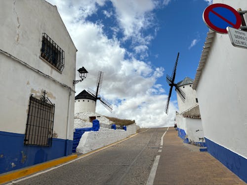 A street with a windmill and a white building