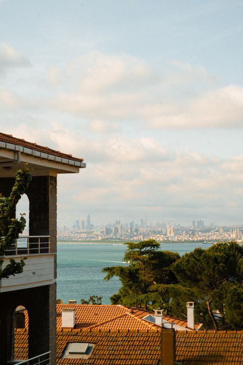 Free Sunny urban skyline with sea view from hillside residential area. Stock Photo