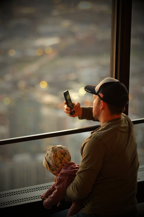 A man and child taking a picture of the city