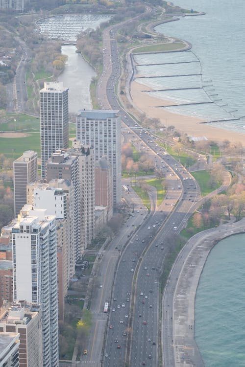 An aerial view of a city with a highway and a beach