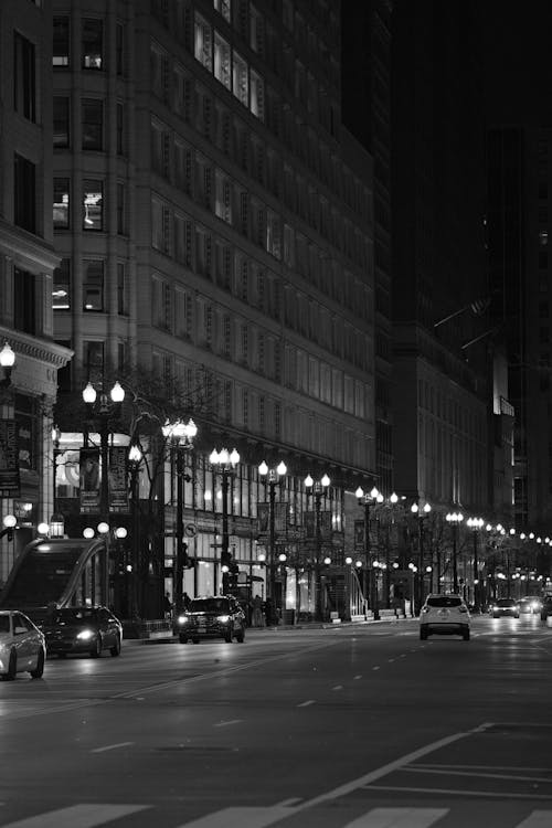 Black and white photograph of a city street at night