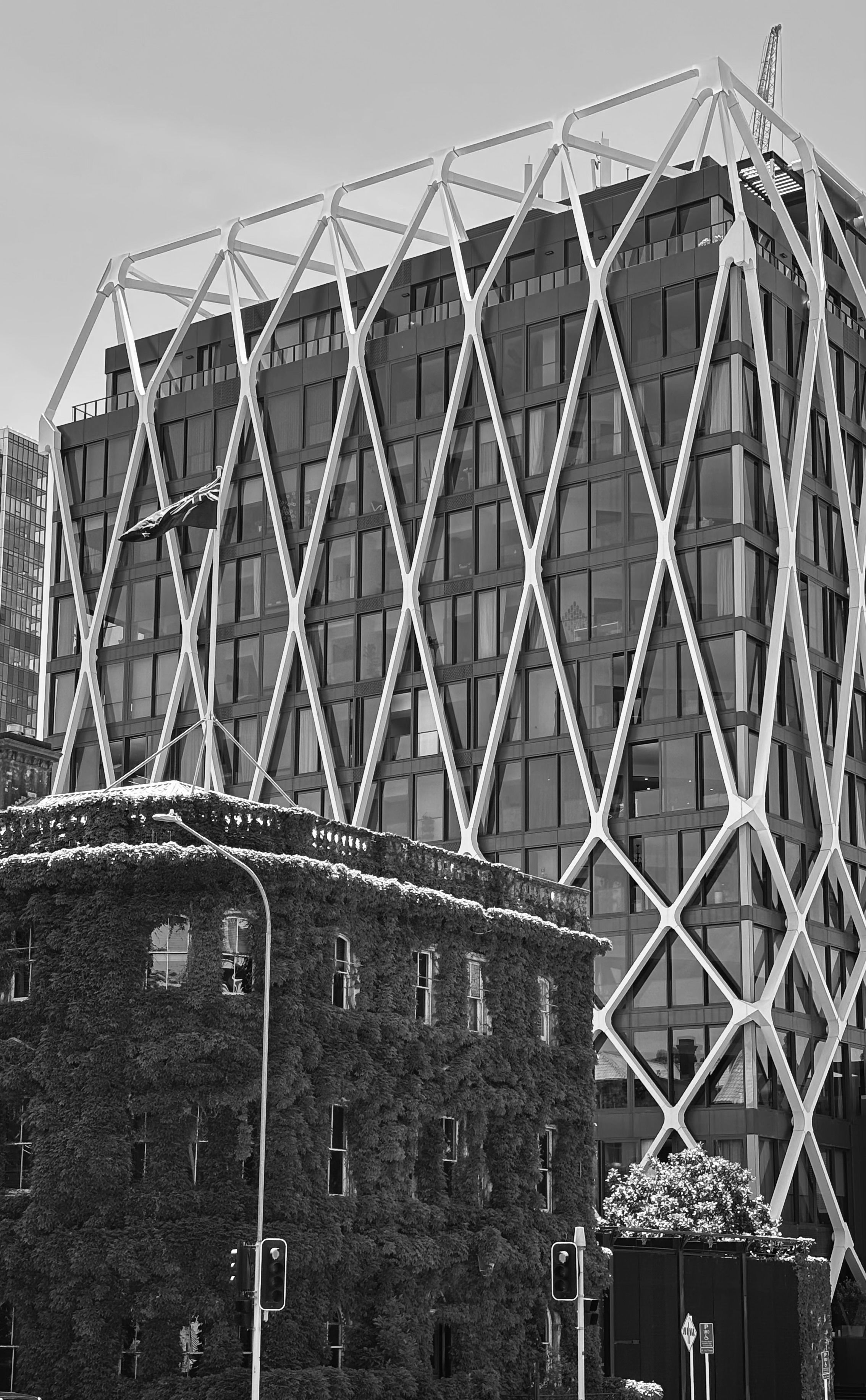Striking modern facade with geometric design in a black and white urban setting.