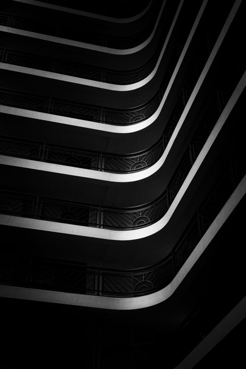 Free A dramatic vertical shot of a modern building's interior with bold geometric patterns. Stock Photo