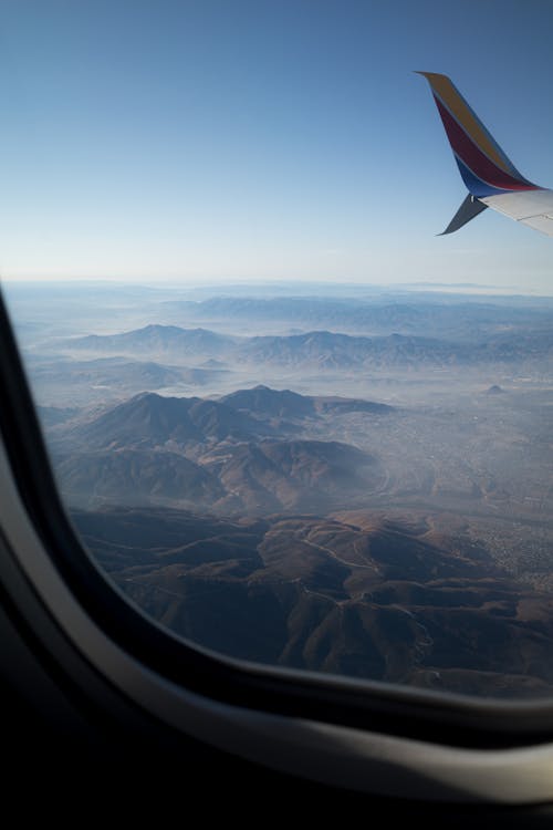 Looking out of window plane over mountains