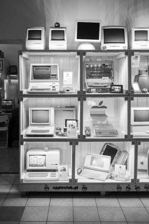 A shelf with a exhibits of Apple computers