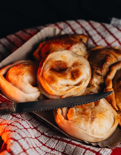 Free Close-up of delicious homemade empanadas on a rustic cloth, highlighting Argentine culinary tradition. Stock Photo