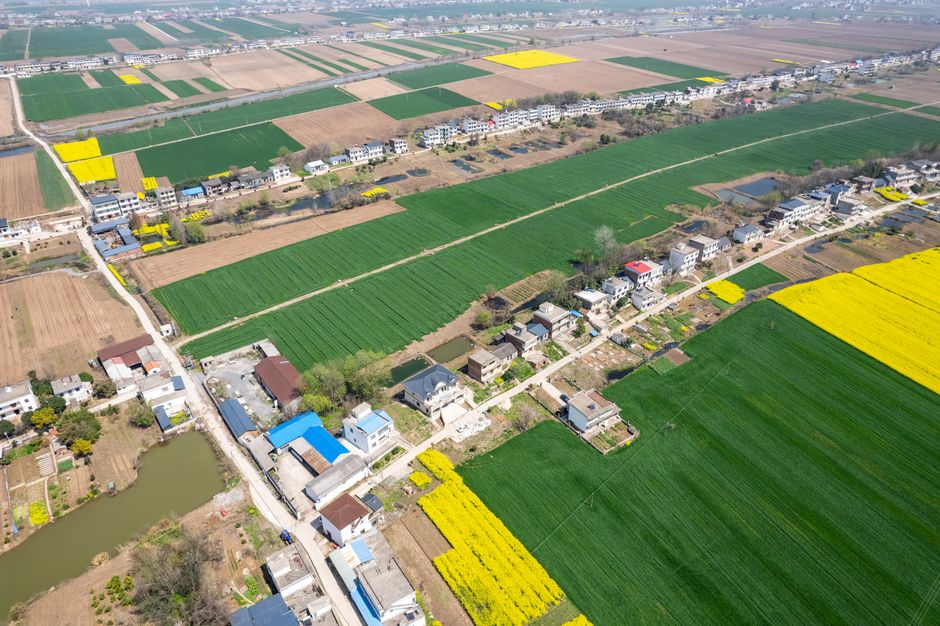 Amazing Mutianyu Great Wall Hiking and Helicopter Tour with Transfers Review 2026 - Aerial shot of lush agricultural fields and village houses in Jiujiang, Jiangxi, China, during summer.