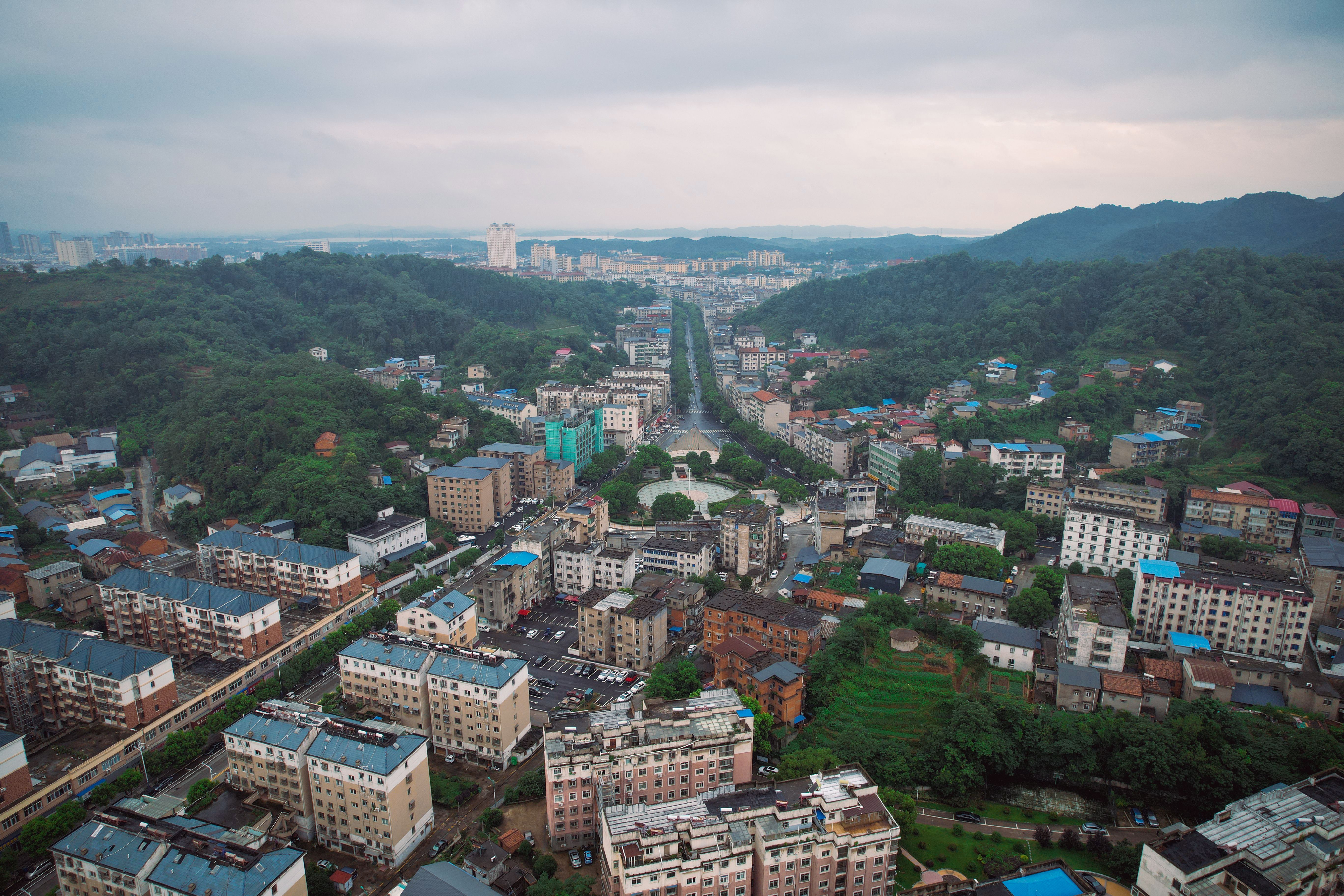 Aerial view of Jiujiang, Jiangxi, China showcasing urban and natural scenery.
