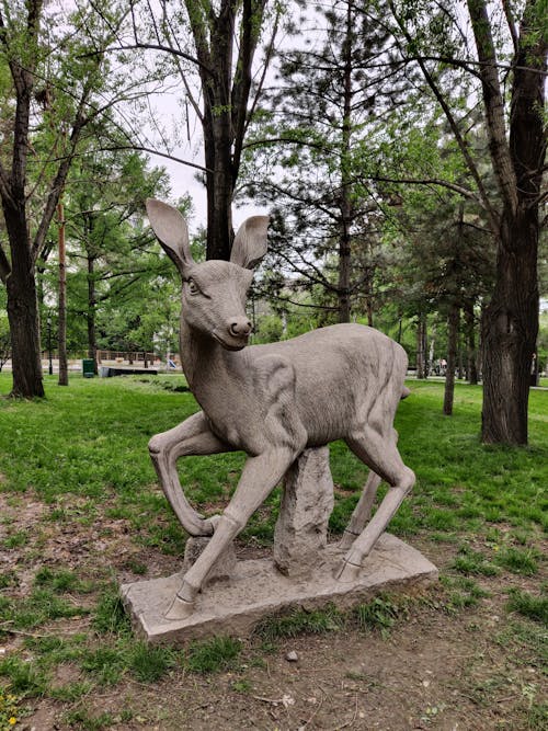 stone statue of deer in the park