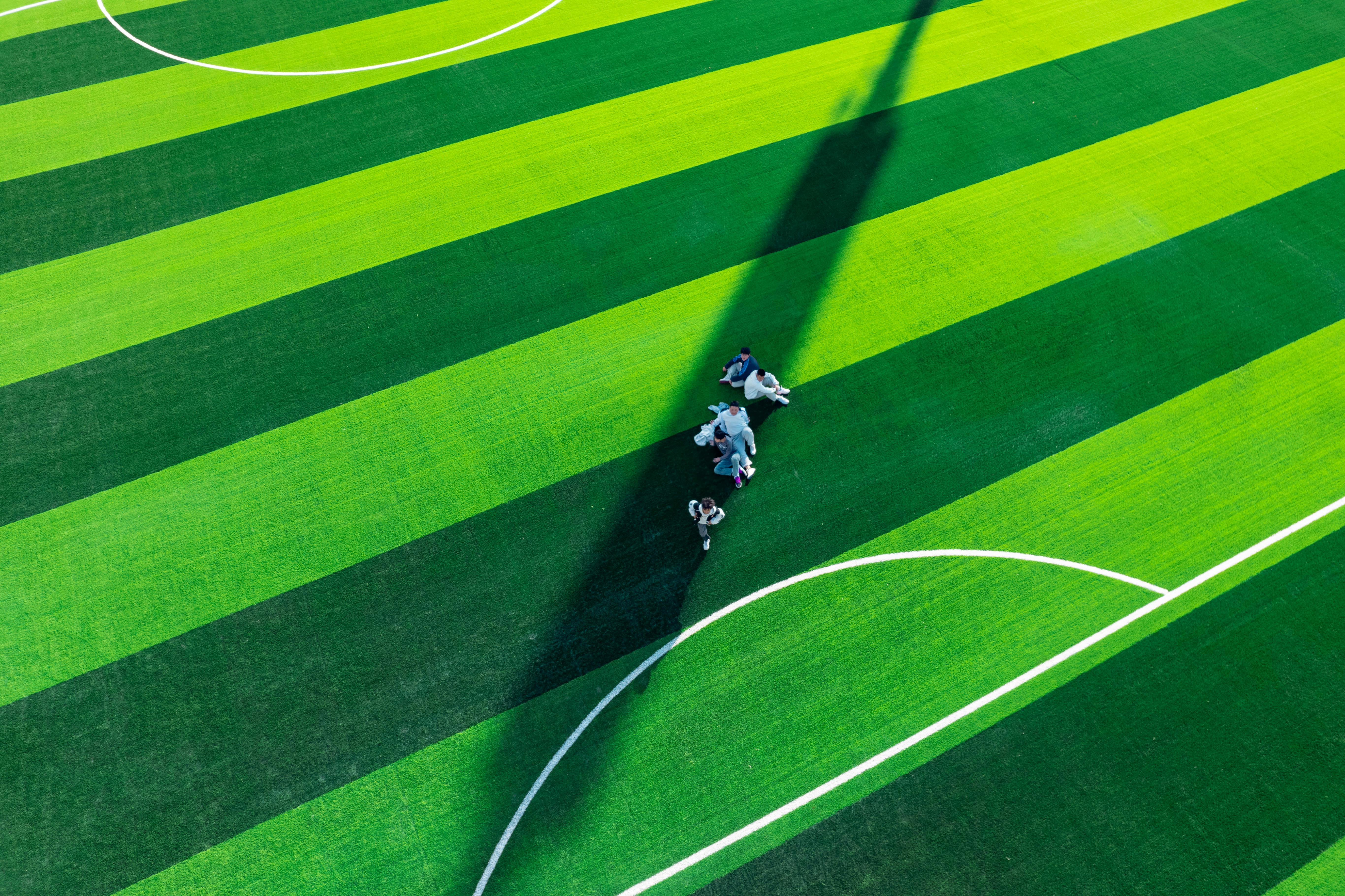 drone shot of teenagers on sports field