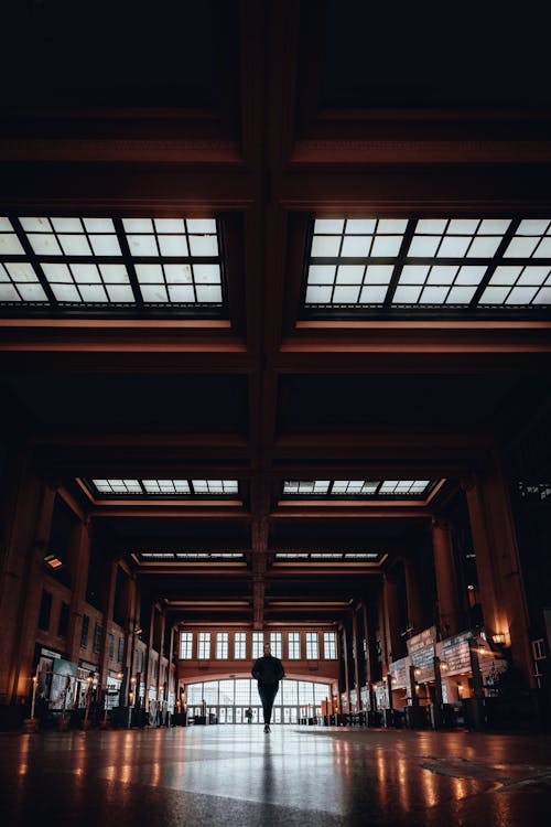 Free A man walking through an empty train station Stock Photo