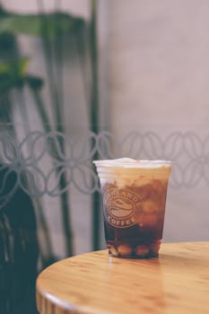 Iced drink from Highland's Coffee on a table with blurred background.