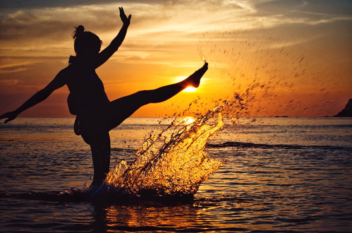 Free Woman in Water during Golden Hour Stock Photo