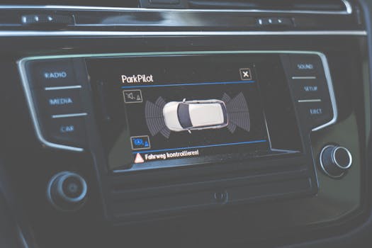 Close-up view of a car dashboard featuring a ParkPilot parking assist display.