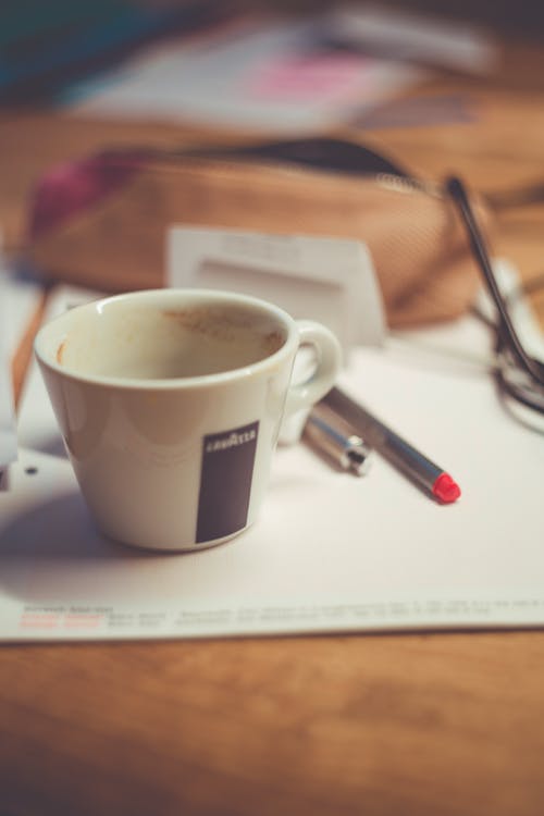 White Ceramic Mug on White Paper