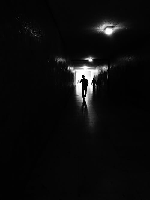 Person Inside Dark Hallway