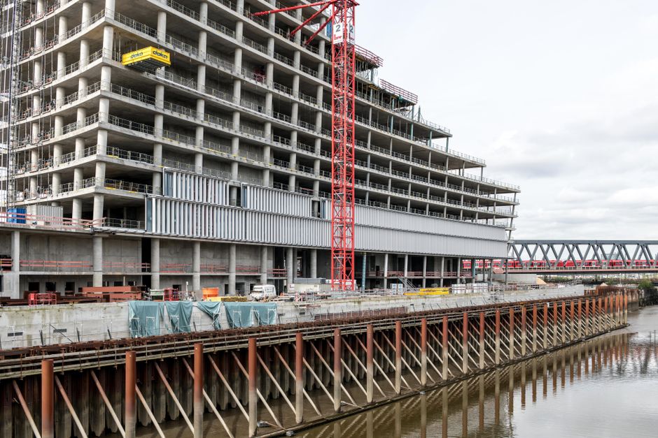 Modern urban construction of a high-rise building with river view in Hamburg.