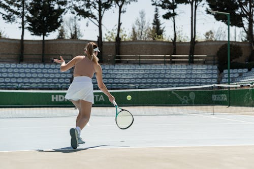 Woman Playing Tennis on a Court 