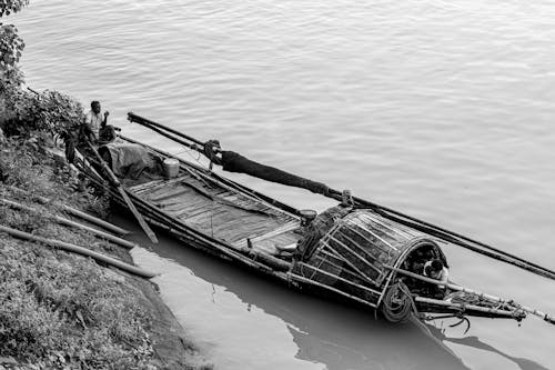 Two fishermen in the boat in Ganga river near Howrah bridge West Bengal, India
