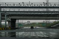 Wet highway scene in İstanbul with bridges and cars on a rainy day.