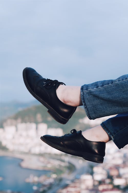 Free Person Wearing Black Lace Up Low Top Sneakers Stock Photo