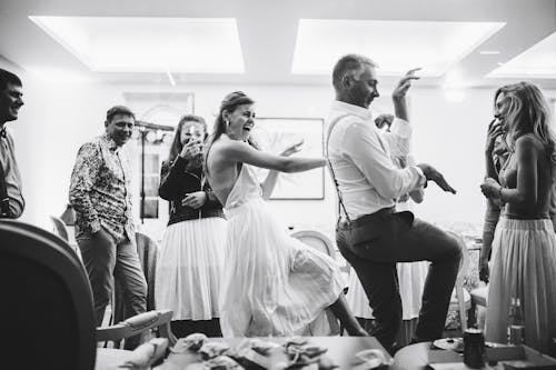 A bride and groom dancing in a room