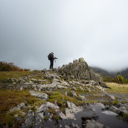 Hiker on a rocky ridge in fog — photo by Kurt Barlow on Pexels