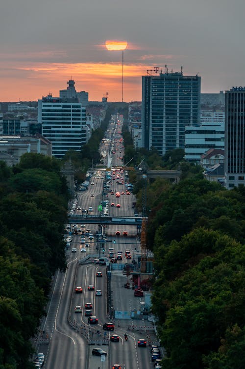 A sunset over a city street with cars