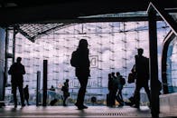 Silhouette of people walking through an airport