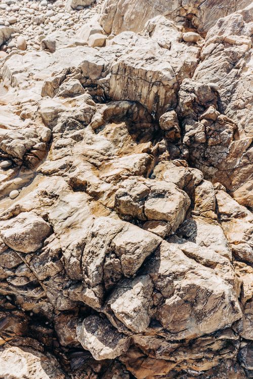 Free Close-up of eroded rocky surface showcasing natural patterns and rugged textures in a dry environment. Stock Photo