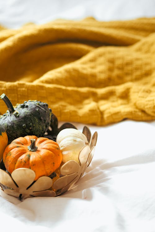 A basket filled with pumpkins and other fall decorations