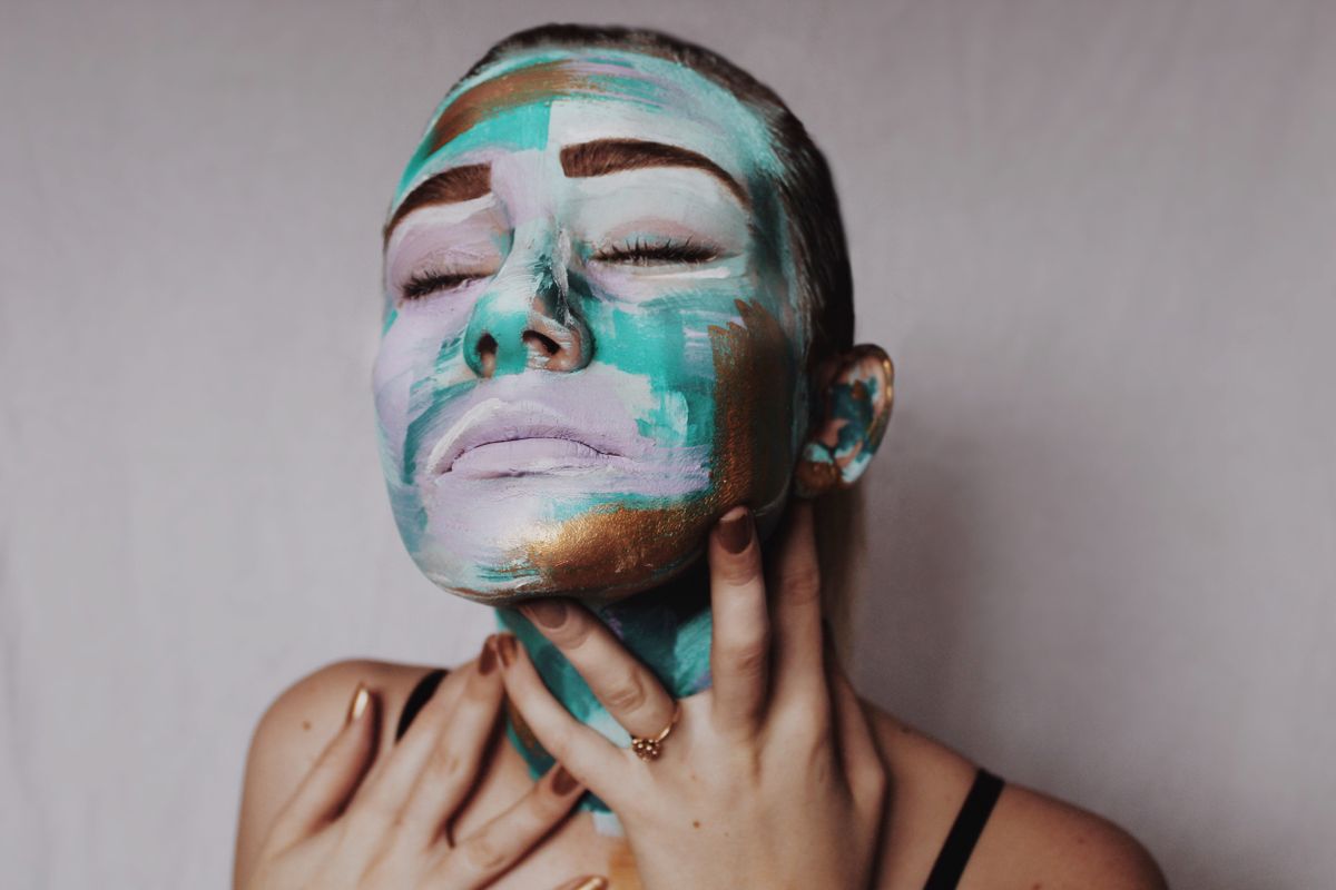 Portrait of a woman in vivid abstract face paint — photo by Anna Taylor on Pexels