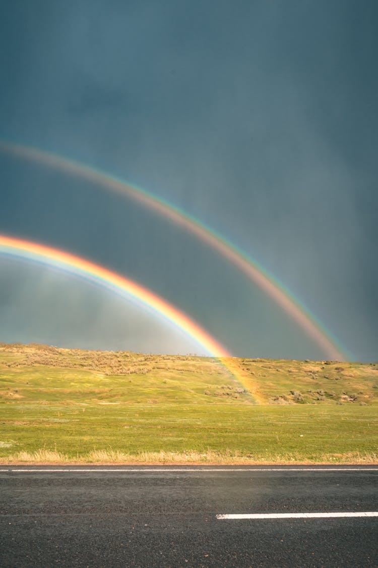 Rainbow Across The Road During Daytije