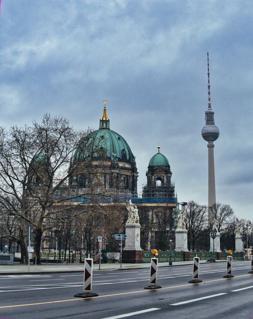 Free Scenic view of Berlin Cathedral and Fernsehturm on a cloudy winter day, capturing urban architecture. Stock Photo