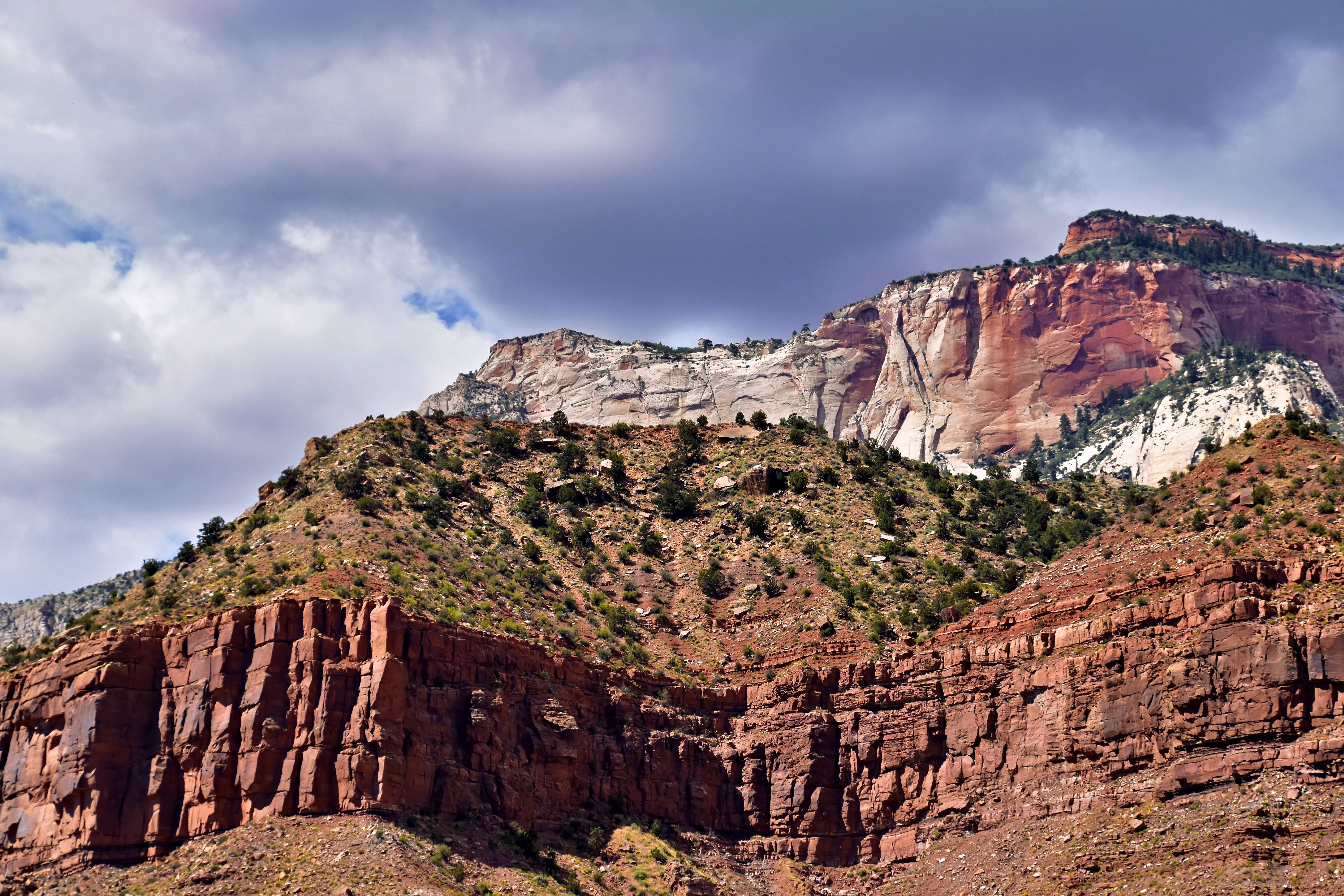 A mountain with red cliffs and clouds · Free Stock Photo