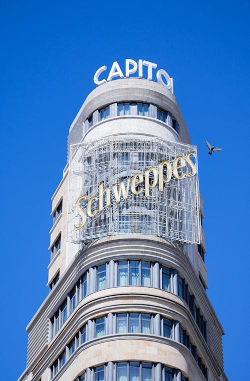 A tall building with a large sign that says capitol