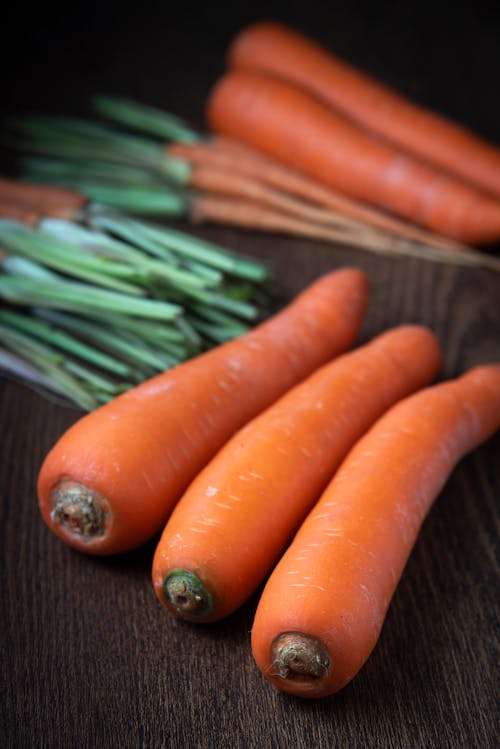 Selective Focus Close-up Photo of Carrots on Wooden Surface