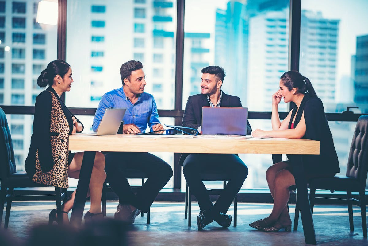 Researcher operating automated liquid handling robots in a modern biology laboratory.