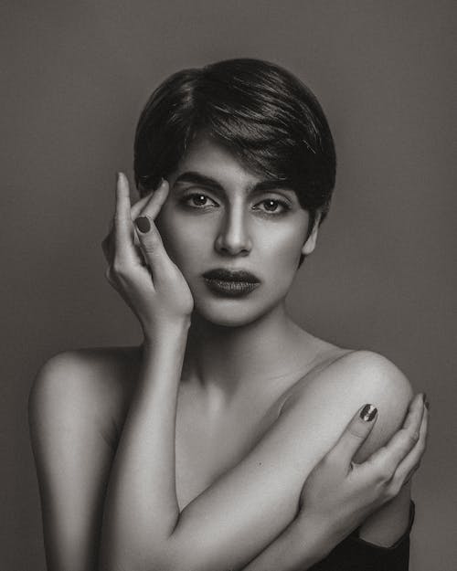 A woman with short hair posing for a black and white photo