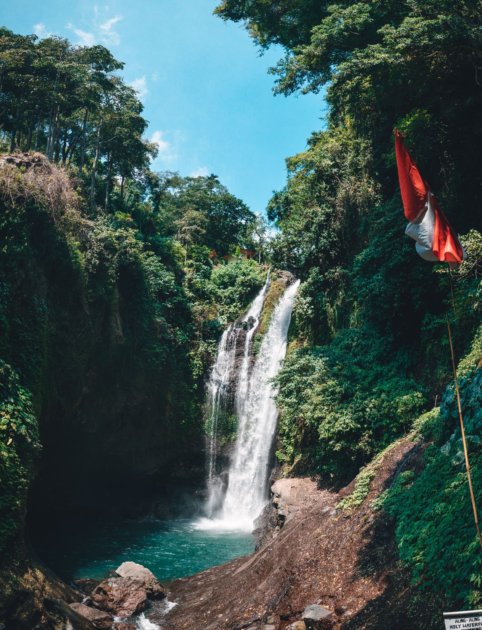 Waterfall cascading through lush green tropical forest