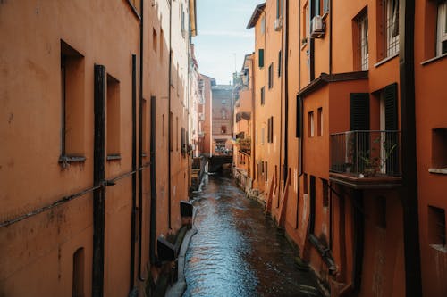 A narrow canal in an orange city