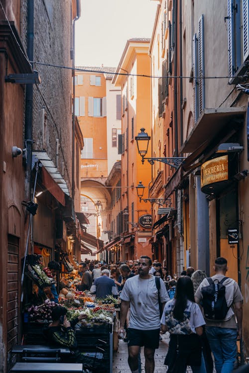 People walking down a narrow alleyway in a city