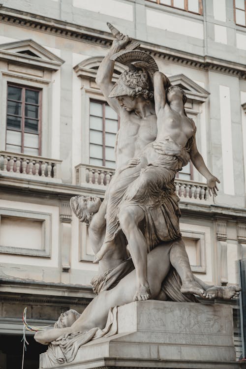 A statue of a man holding a woman on his back