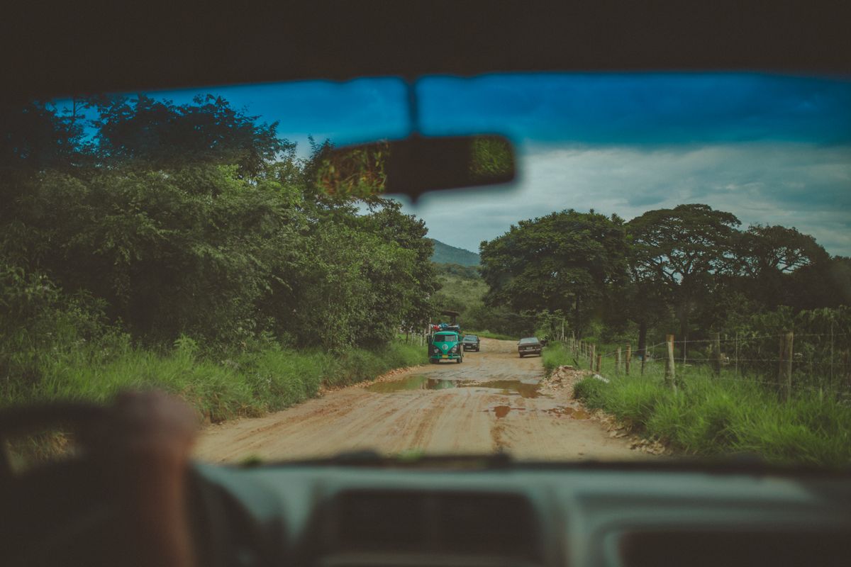 Driver point-of-view through the windshield on a remote unpaved backcountry dirt road