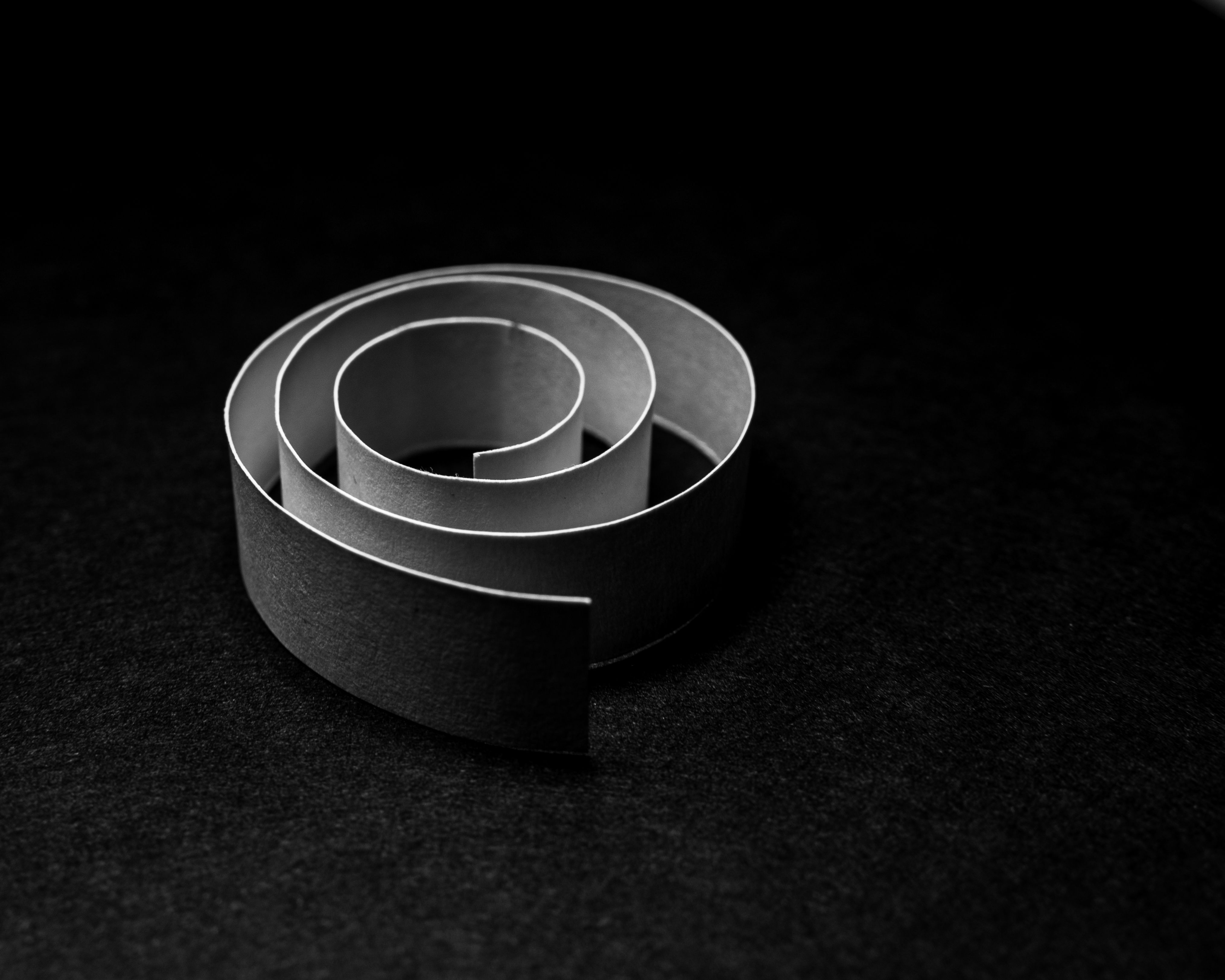 Elegant black and white spiral paper art captured with close-up details.